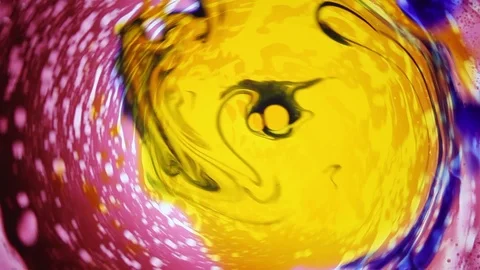 Abstract spinning liquid dye pattern, red yellow and blue color Stock Footage 124284531