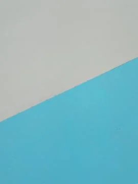 Abstract split composition of light grey and bright blue textured surface Stock Photos