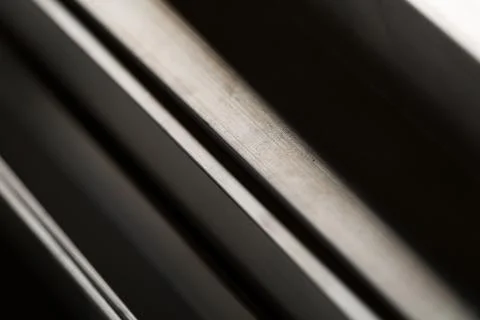 Abstract stack of aluminium profiles close up, industrial background macro 스톡 사진