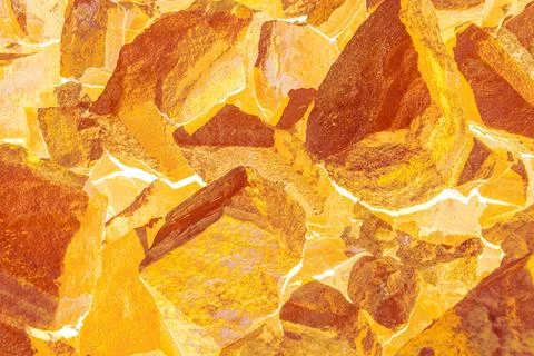 Abstract stone texture with glowing orange and gold palette and white energy Stock Photos