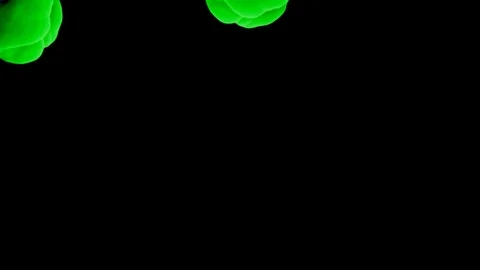 Abstract stylized Green ink drop in water on a black background V11 Stock Footage 87565261