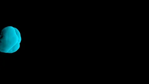 Abstract stylized Light Blue ink drop in water on a black background V1 Stock Footage 87565302