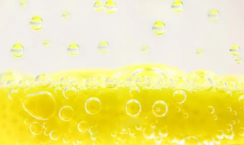 Abstract summer background. Bubbles in water with lemon. Stock Photos