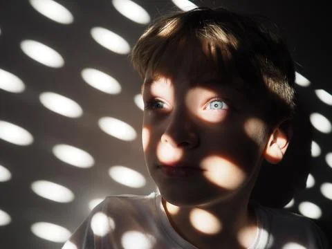 Abstract sun rabbits ovals and dots. The face of a cute child with blue eyes. 写真素材