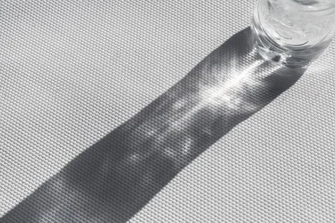 Abstract sunlight refraction pattern illuminates shadow Stock Photos