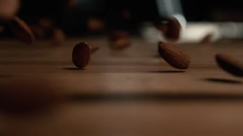 Abstract Super Slow Motion of Almonds Falling to a Wood Counter Video stock 270401704