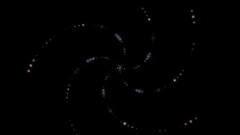 Abstract swirl of multicolored light dots against a solid black background Video stock 335117558