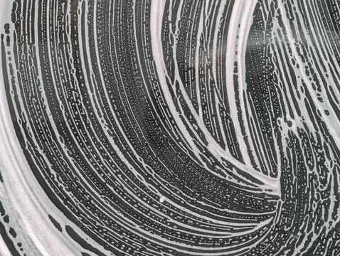 Abstract swirl pattern in soapy water Stock Photos