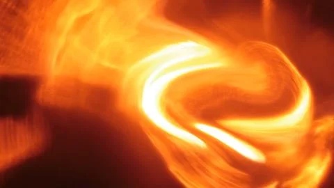 Abstract swirling light patterns in vibrant orange and yellow hues Иллюстрация
