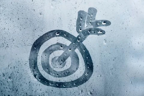 Abstract target with arrow on misted window Foto stock