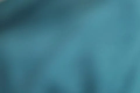 Abstract teal blue fabric texture background with soft folds and smooth sil.. Stock Photos