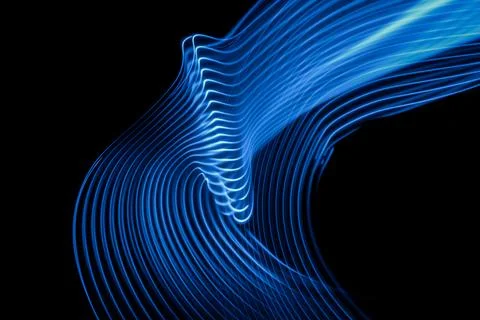 Abstract technology background of long exposure neon light stripes on black. Stock Photos