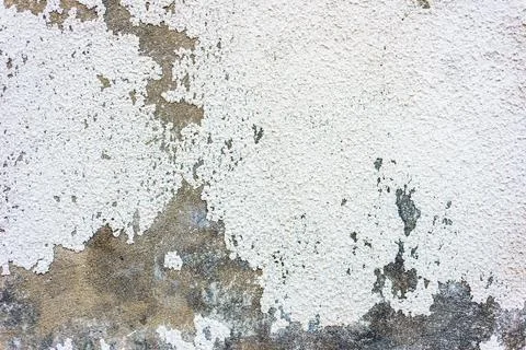 Abstract texture background of an aged white concrete wall with peeling paint Stock Photos