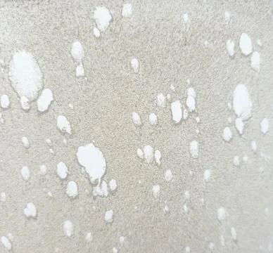 Abstract texture background shows sand with white paint splatters and dropl.. Stock Photos
