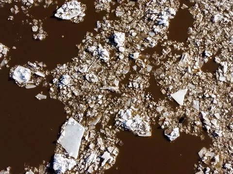 Abstract texture of broken white ice and dark water at winter. Stock Photos