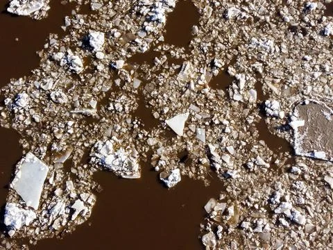 Abstract texture of broken white ice and dark water at winter 스톡 사진