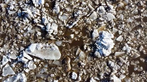 Abstract texture of broken white ice and dark water at winter. Stock Photos
