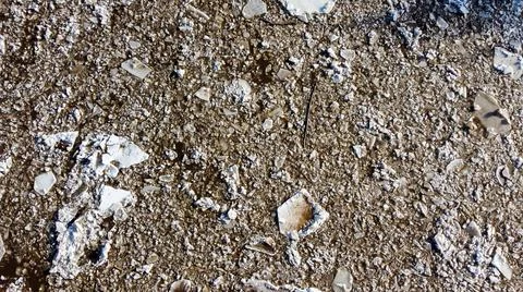 Abstract texture of broken white ice and dark water at winter. Spring is coming. Stock Photos