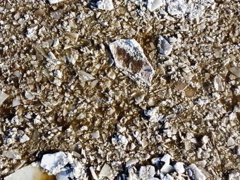 Abstract texture of broken white ice and dark water at winter. Spring is coming. Stock Photos