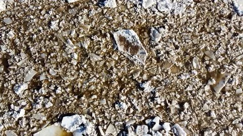 Abstract texture of broken white ice and dark water at winter. Spring is coming. Stock Photos
