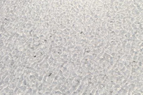 Abstract texture of broken white ice. View of the ice from a drone. Stock Photos