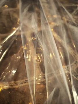 Abstract texture of crumpled transparent plastic film wrap. Fotos Stock