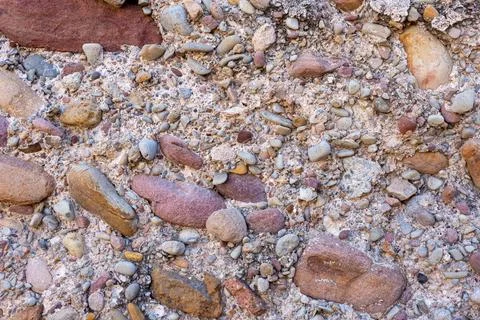 Abstract texture of different size stones in a piece of concrete Stock Photos