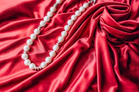 Abstract texture of draped red silk background with pearls Stock Photos