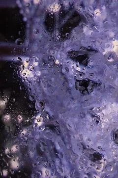 An abstract texture featuring water droplets or a frost pattern on glass in.. Stock Photos