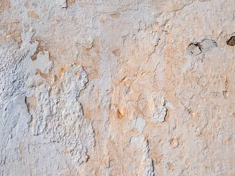 Abstract texture of an old beige weathered wall with cracked and peeling pl.. Stock Photos
