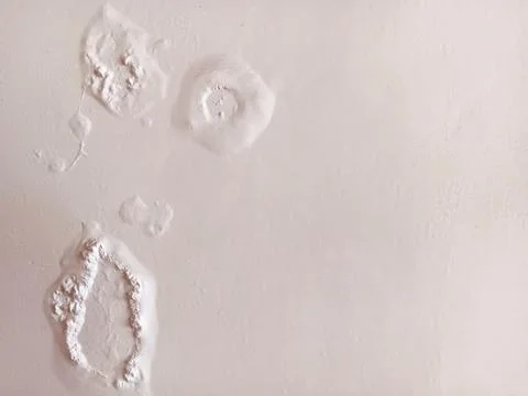 Abstract texture of paint blisters or bubbles on a white wall. Stock Photos