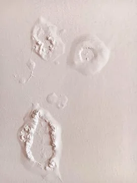 Abstract texture of paint blisters or bubbles on a white wall. Stock Photos