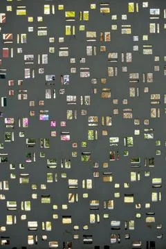 Abstract texture pattern of small window openings and perforations on a modern Stock Photos