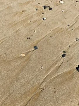 Abstract texture of the sand in the beach, closeup of photo Stock Photos