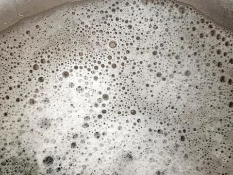 Abstract texture of thick soap foam with many small and large grey water bubbles Stock Photos
