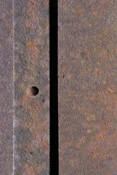 Abstract texture of weathered rusty metal sheets with a rivet Stock Photos