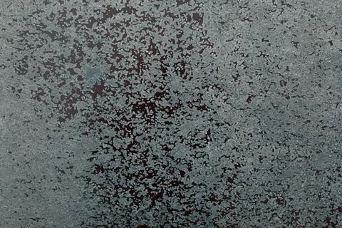 Abstract textured background created with gray particles on a dark surface Stock Photos