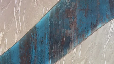 Abstract textured wall with blue and beige tones creating a dynamic visual .. Vidéo 340220545