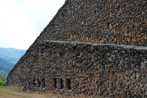 Abstract textured wall made of stacked log cross-sections. Stock Photos