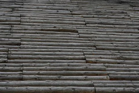 Abstract textured wall made of stacked log cross-sections. Stock Photos