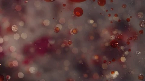 Abstract tiny clear liquid bubbles and blood red splatter movement background Stock Footage 118281932