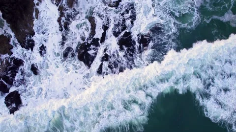 Abstract top down foamy ocean waves crashes rock Stock Footage 220688517