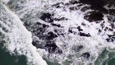 Abstract top down foamy ocean waves crashes rock Stock Footage 220688582