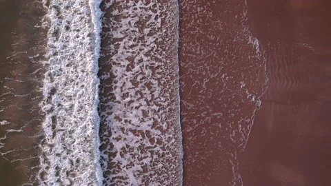 Abstract top down foamy ocean waves breaks beach Stock Footage 220688594