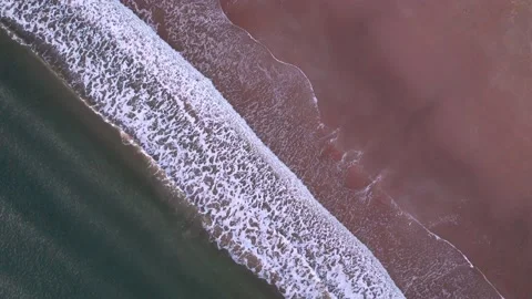 Abstract top down foamy ocean waves breaks beach Stock Footage 220688605
