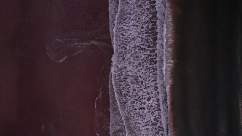 Abstract top down foamy ocean waves breaks beach Stock Footage 220833616