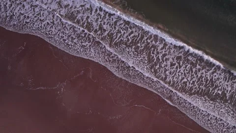 Abstract top down foamy ocean waves breaks beach Stock Footage 220833793