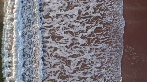 Abstract top down foamy ocean waves breaks beach Stock Footage 220833954