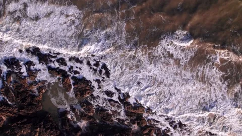 Abstract top down foamy ocean waves crashes rock Stock Footage 220917645