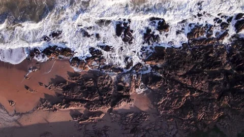 Abstract top down foamy ocean waves crashes rock Stock Footage 222046908